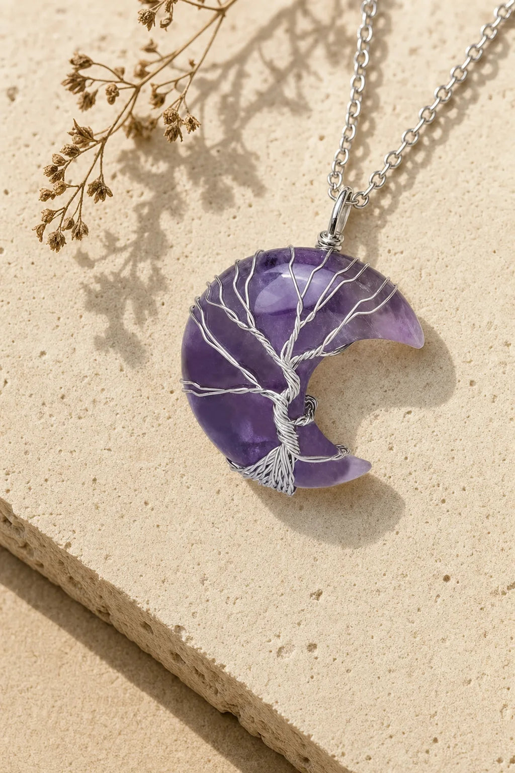 Crystal Moon Tree of Life Necklace - Healing Pendant, ZAIA jewelry, hero view. Warm travertine editorial image. Warm natural light, low-contrast editorial photography.