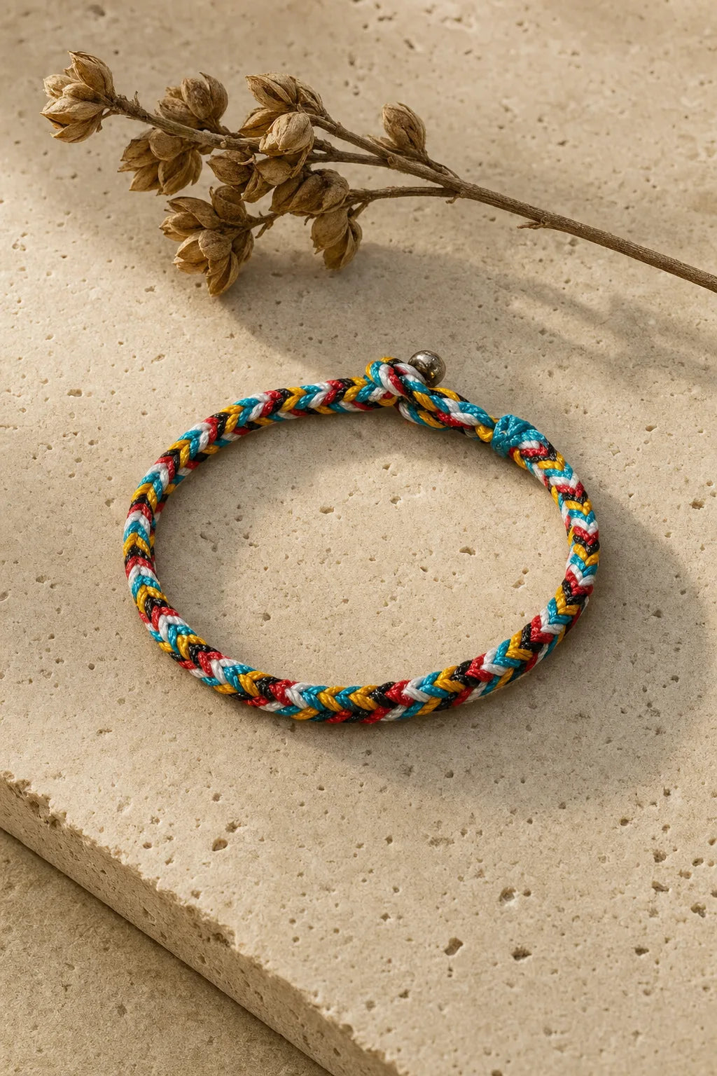 Five Colour Thread Bracelet, ZAIA jewelry, hero view. HERO — Editorial still life. Warm natural light, low-contrast editorial photography.