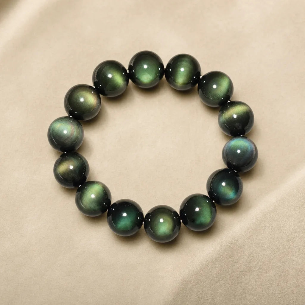 Green Eye Obsidian Bracelet, ZAIA jewelry, pack view. PACK — Studio product. Warm natural light, low-contrast editorial photography.