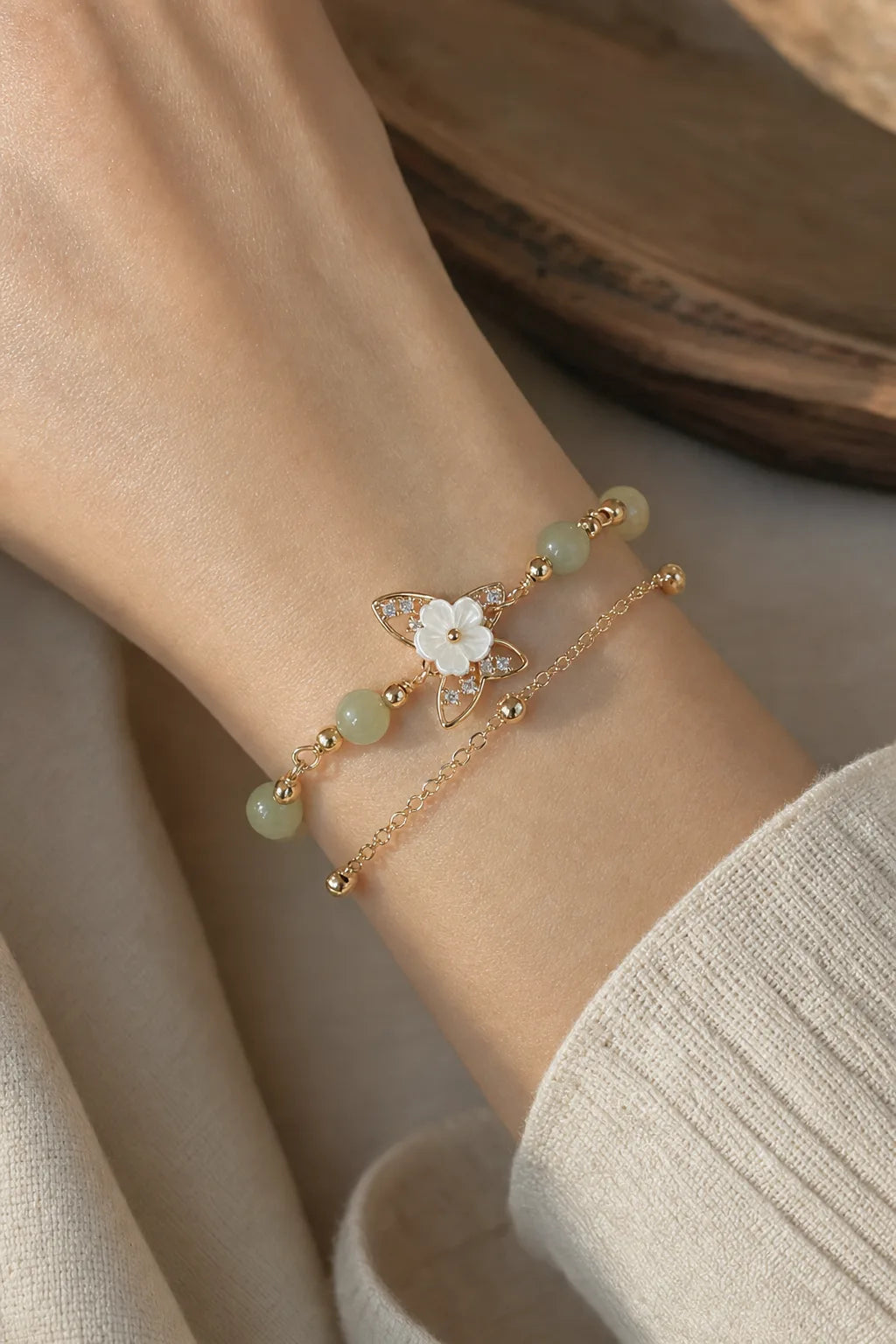 Jade Butterfly Bracelet, ZAIA jewelry, worn view. WORN — Lifestyle worn. Warm natural light, low-contrast editorial photography.