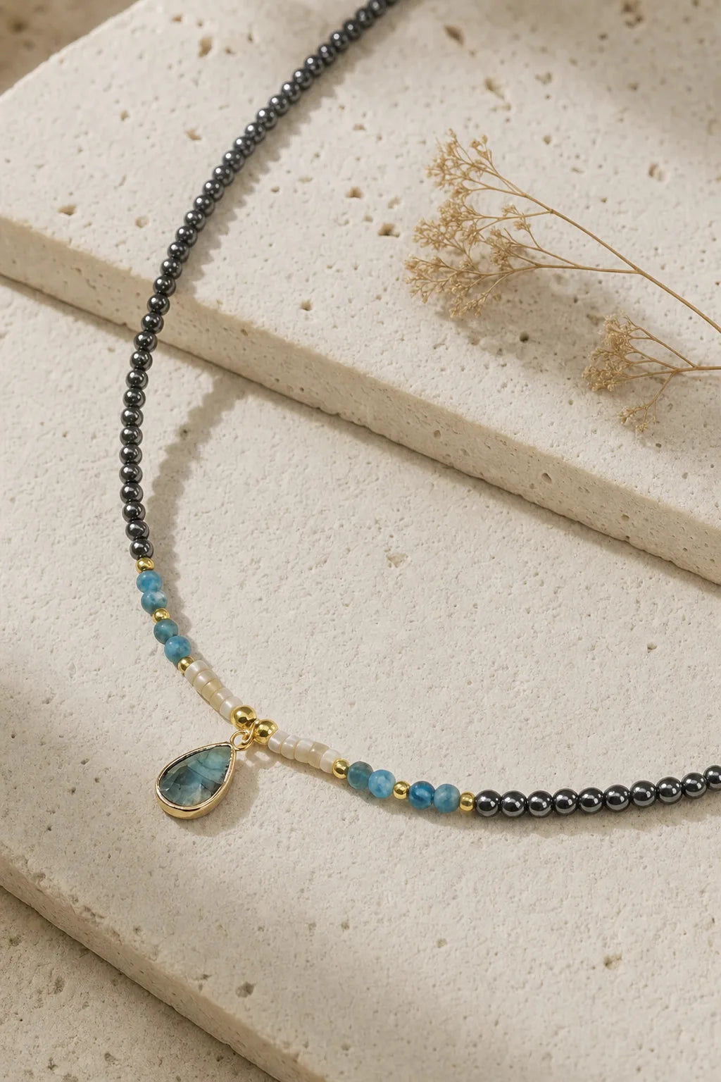 Divine Drop Necklace - Natural Gemstone Pendant, ZAIA jewelry, hero view. HERO — Editorial still life. Warm natural light, low-contrast editorial photography.