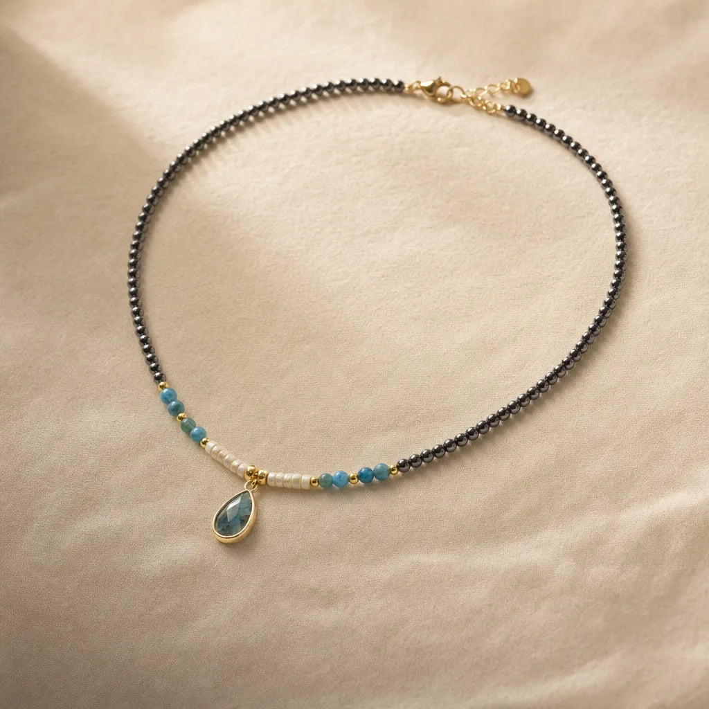 Divine Drop Necklace - Natural Gemstone Pendant, ZAIA jewelry, pack view. PACK — Studio product. Warm natural light, low-contrast editorial photography.