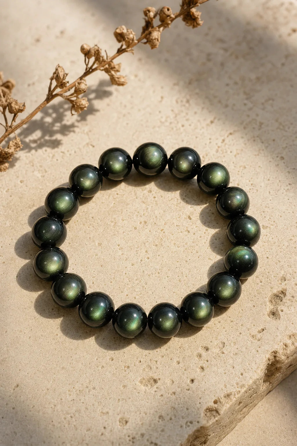 Green Eye Obsidian Bracelet, ZAIA jewelry, hero view. HERO — Editorial still life. Warm natural light, low-contrast editorial photography.