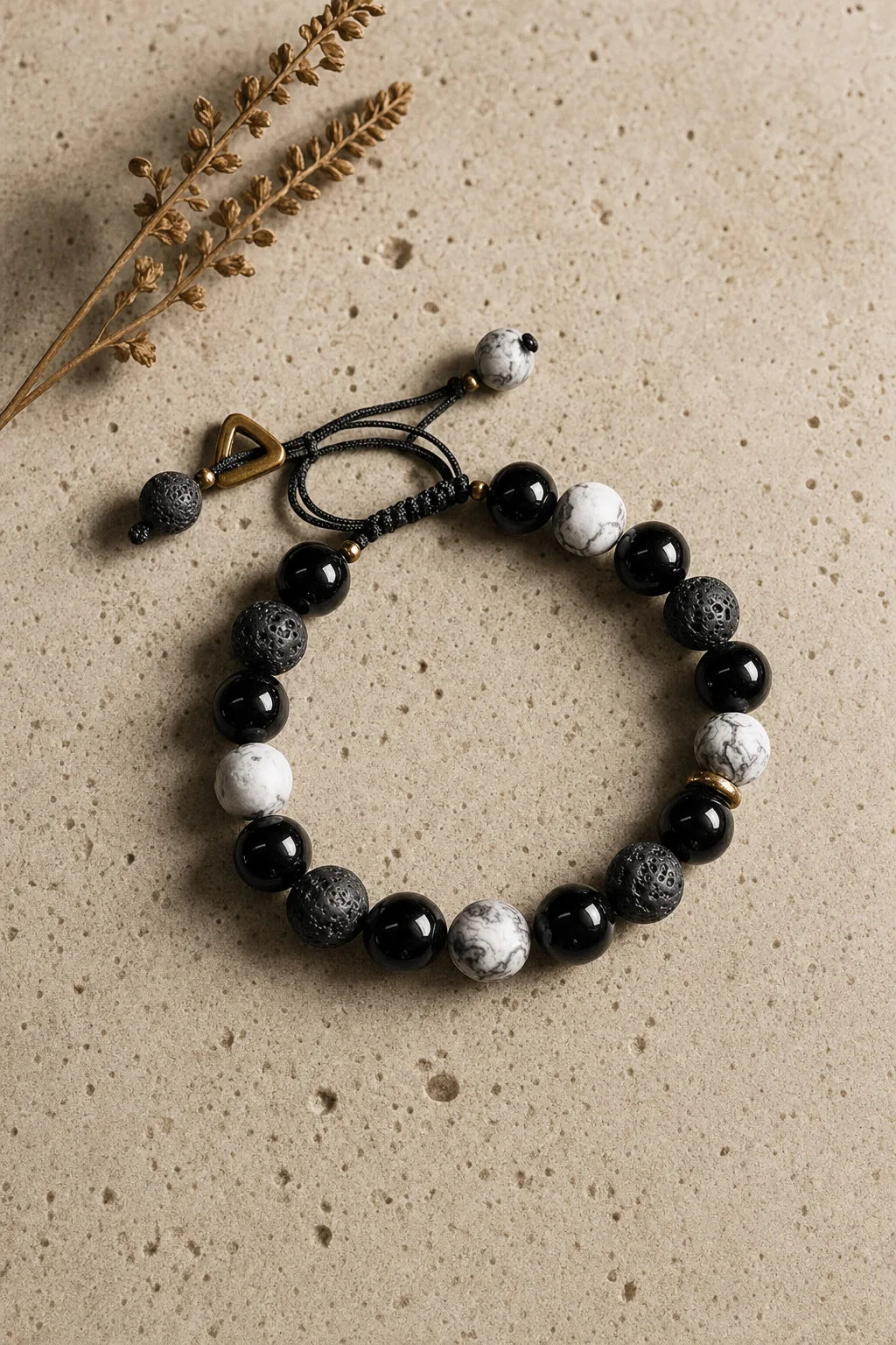 Obsidian & Lava Yin Yang Bracelet, ZAIA jewelry, hero view. HERO — Editorial still life. Warm natural light, low-contrast editorial photography.