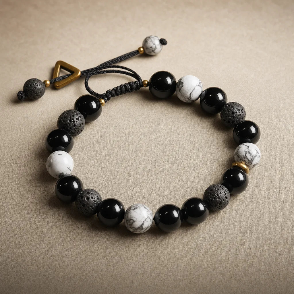 Obsidian & Lava Yin Yang Bracelet, ZAIA jewelry, pack view. PACK — Studio product. Warm natural light, low-contrast editorial photography.
